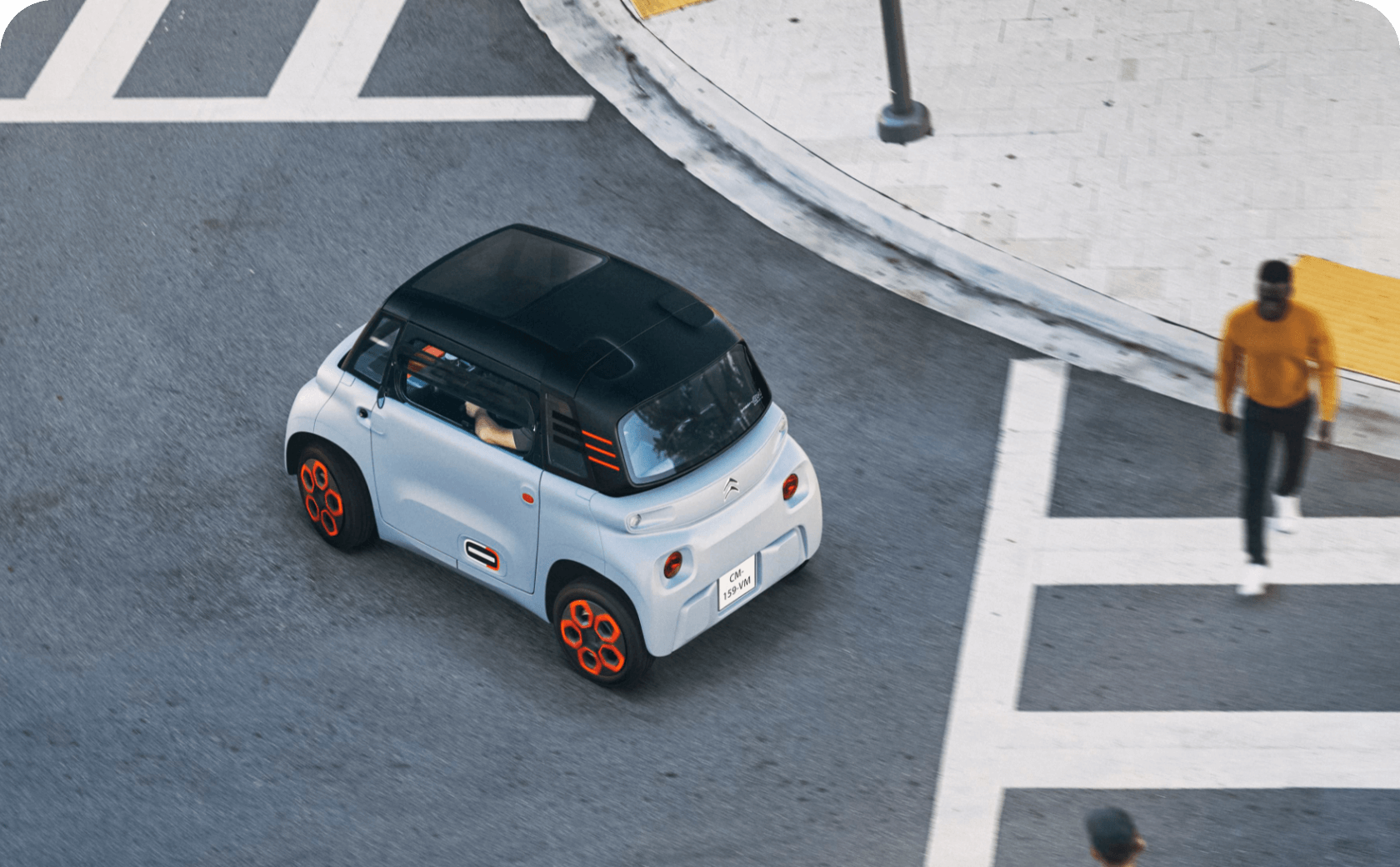 A grey Citroën Ami on a city road