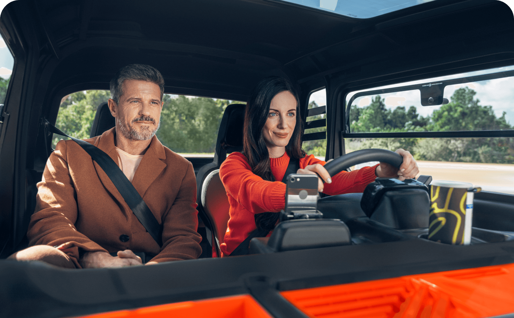 A couple into a Citroën Ami, the woman is driving